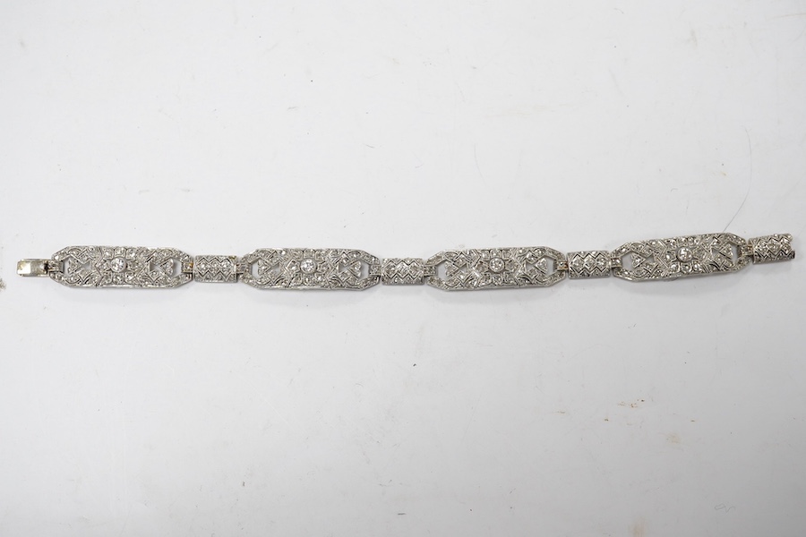 An early 20th century pierced white gold and millegrain set diamond cluster bracelet, set with round and rose cut stones, 18.1cm, gross weight 18.1 grams. Condition - fair to good